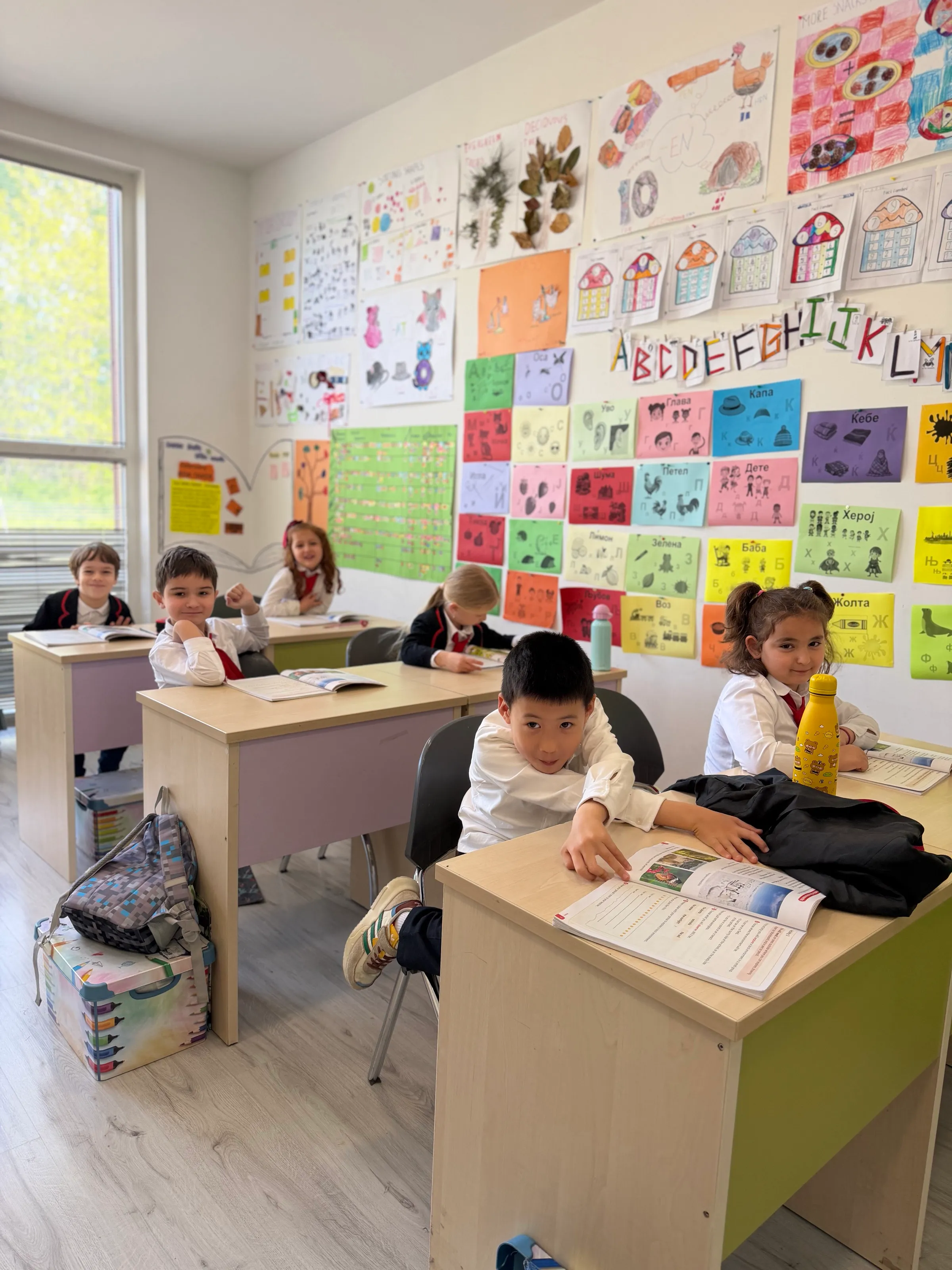 The classroom by June — walls covered with a year of alphabet cards, numbers, and artwork