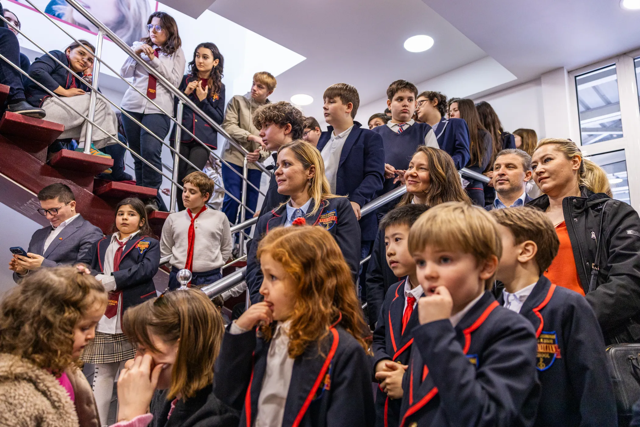 Students, parents, and teachers gathered together on the school staircase