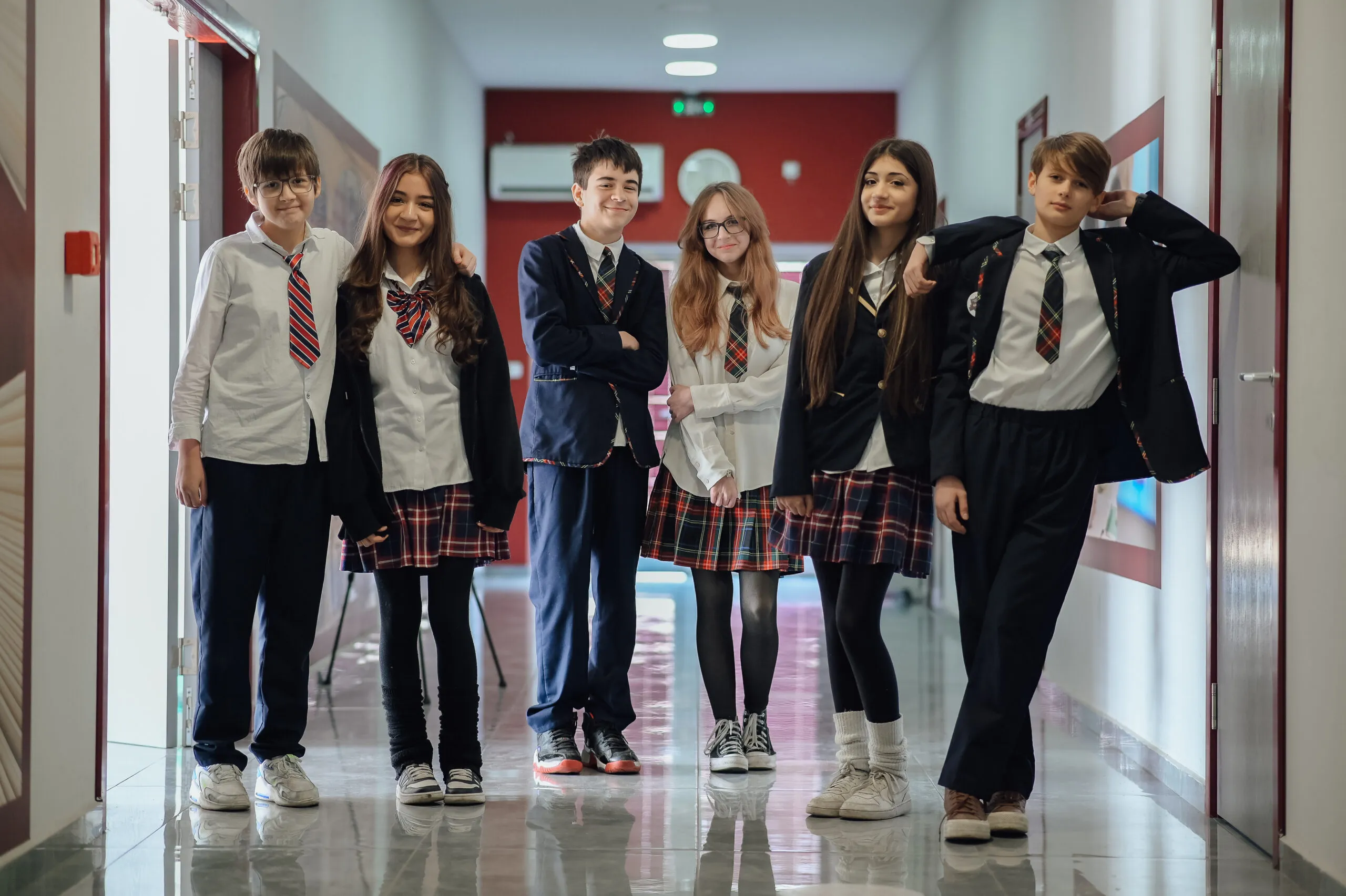 Six secondary students in uniform in the school hallway