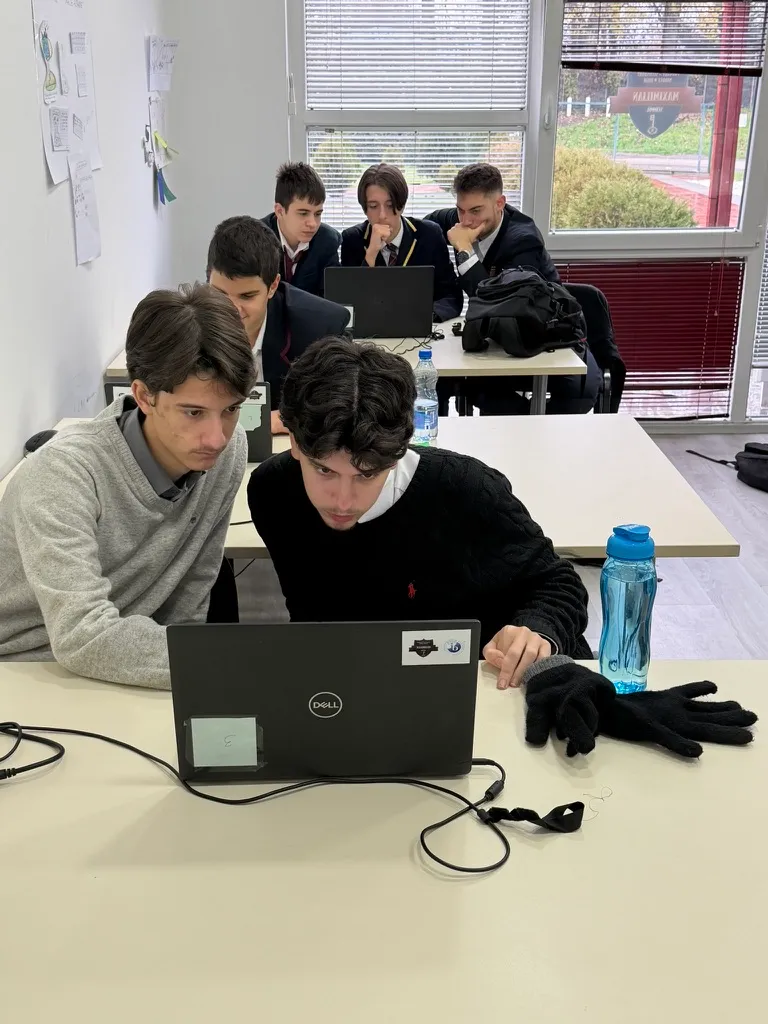High school students working together on laptops in class